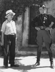 Lampros Konstantaras takes the place of an Italian officer, proudly wearing his uniform, in Michalis Gaziadis and Giannis Filippou's film Anna Roditi. He is shown with Nikos Matthaios (left) in this photograph.