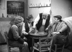 The great actor of the Greek theatre, Aimilios Veakis, serving Fragkiskos Manellis, Mimis Fotopoulos and  Konstantaras in a scene from the film Apaches of Athens, directed by Ilias Paraskevas